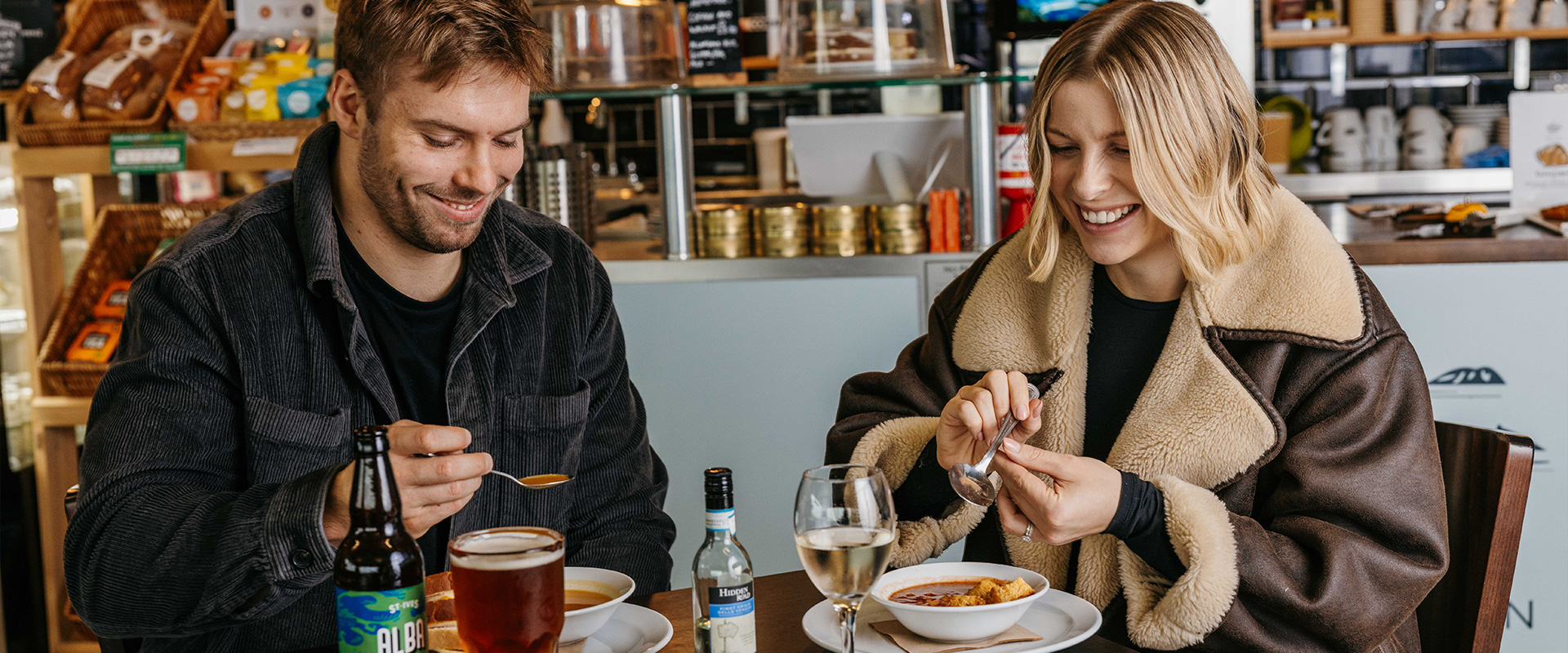Couple eating at western rocks cafe at Land's End Airport, Cornwall